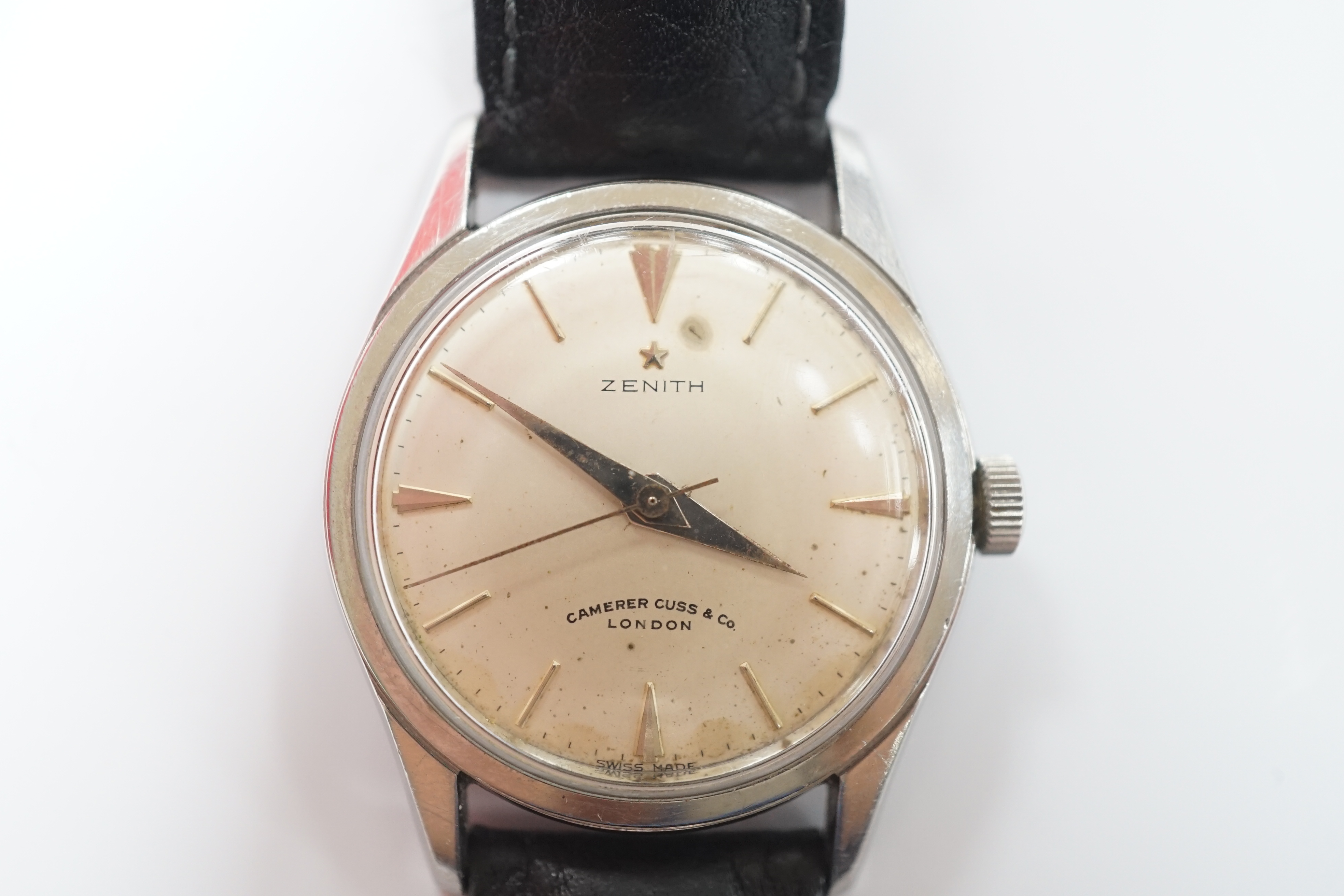 A gentleman's stainless steel Zenith manual wind wrist watch, retailed by Camerer Cuss & Co, London, on associated leather strap.